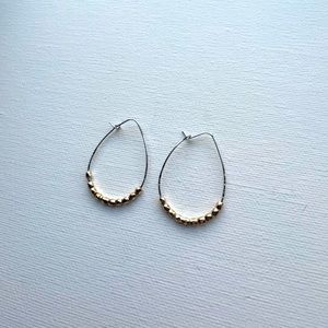 Silver tear drop wire hoop with gold beads
